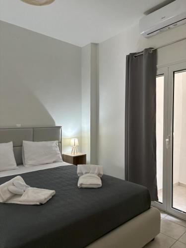 Ένα ή περισσότερα κρεβάτια σε δωμάτιο στο Emari Apartments