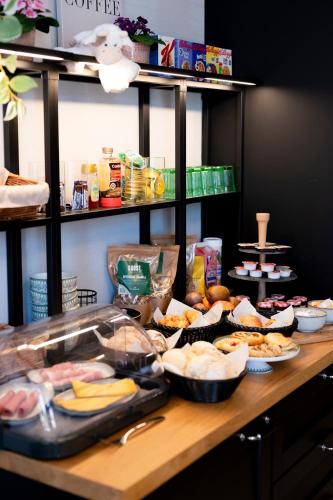 a table topped with plates of food on a counter at BnB De Koepoort in Mechelen