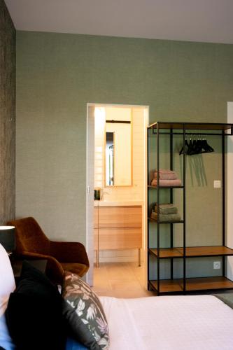 a room with a bed and a room with a mirror at BnB De Koepoort in Mechelen