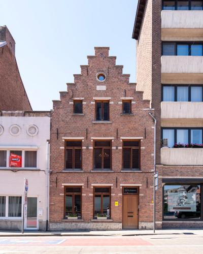 a red brick building with a clock on it at BnB De Koepoort in Mechelen