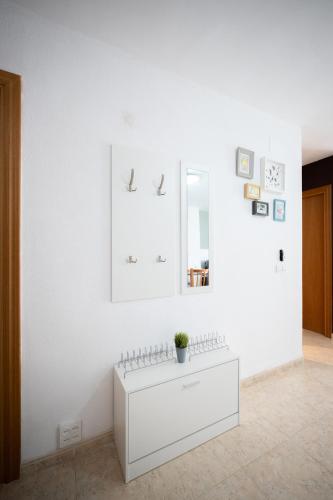 a white room with a dresser and a mirror at Apartalux Magic Paradise in Oropesa del Mar