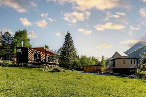 a house and a building on a grass field at Buda 2 in Komjatná