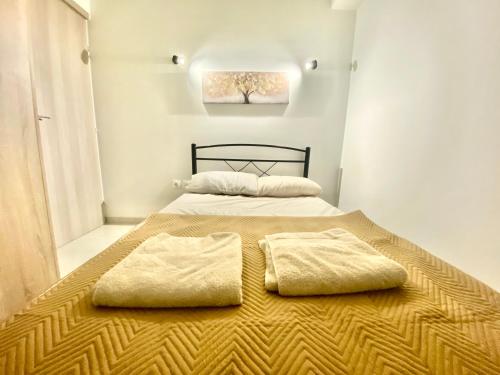A bed or beds in a room at The Urban Nest Thessaloniki