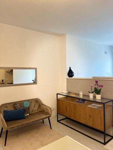 a living room with a couch and a table at Urban House in Nuoro