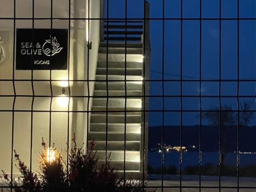 a building with a sign on the side of it at seaandolive in Ammouliani