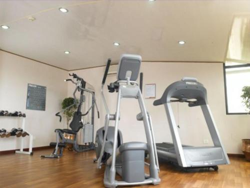 a gym with several exercise bikes in a room at Classic Sarovar Portico Trivandrum in Trivandrum