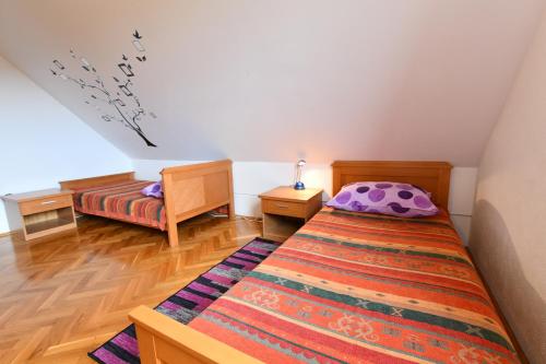 a small bedroom with a bed and a rug at Apartment Anna in Saborsko