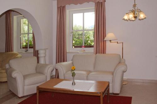 a living room with two chairs and a table at PRIVILLAGE Stare - Villa & Chalet in Bohinj