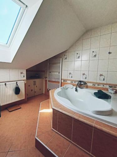 a large bathroom with a large tub in a attic at Welcome Home in Kutná Hora