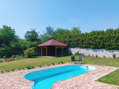 a swimming pool in a yard with a gazebo at Welcome Home in Kutná Hora