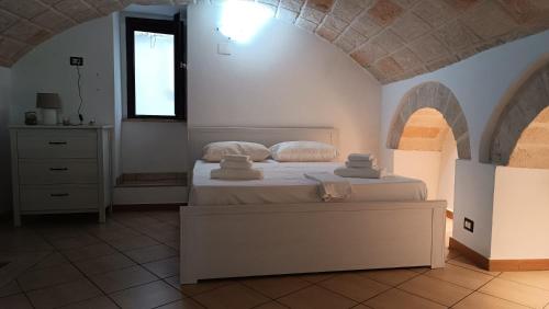 a bedroom with a bed with two pillows on it at Dimora Pugliese in Monopoli