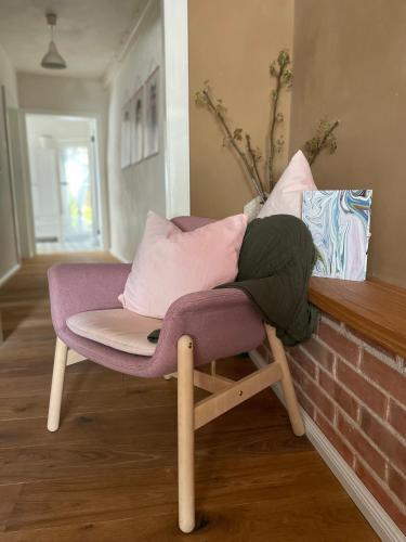 a purple chair with pillows on top of a counter at Kochstedter Wohnstuben - Wohnen mit Naturbaustoffen in der Bauhausstadt Dessau in Dessau