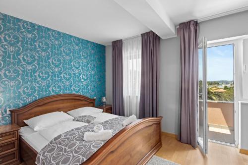 a bedroom with a bed with a teddy bear on it at Minerva Hotel in Medulin