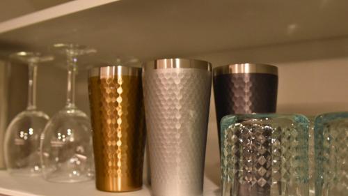 a group of glass vases and glasses on a shelf at Private Villa AZUL 南房総 千倉 海徒歩4分 ペット可 サイクリスト対応 in Minamiboso