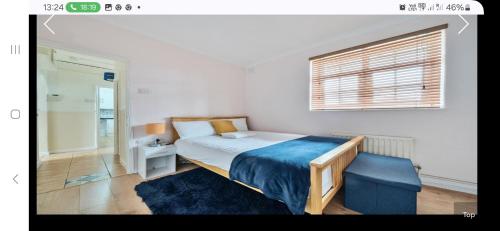 a bedroom with a bed and a blue chair at The Wheatland House in London