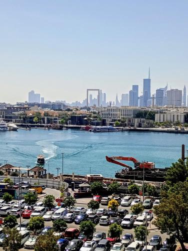 a parking lot with cars parked next to a river at Wow Amazing BurjKhalifa,Sea,Sunset,Ship,Park,Metro View,Private Home 2BHK ,Fully Furnished in Dubai