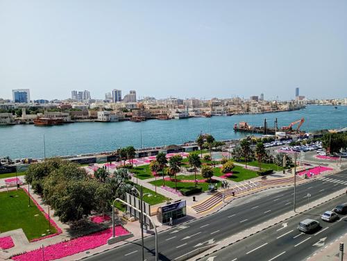an aerial view of a city with a river at Wow Amazing BurjKhalifa,Sea,Sunset,Ship,Park,Metro View,Private Home 2BHK ,Fully Furnished in Dubai