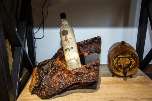 a bottle of wine sitting on top of a table at Apartmani Stone oasis in Zupci
