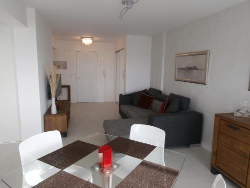 a living room with a couch and a table at Iberia Beach Front Sea in Juan-les-Pins