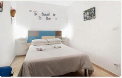 Ένα ή περισσότερα κρεβάτια σε δωμάτιο στο Ginevra Rooms