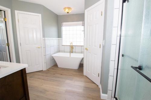 a bathroom with a bath tub and a window at The Zen Den in Waynesville