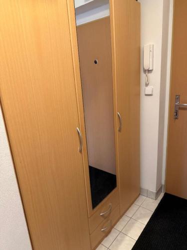 a wooden door with a mirror in a bathroom at KEY Accommodation Brno in Brno