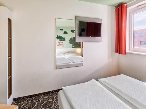 Postel nebo postele na pokoji v ubytování B&B Hotel Aschaffenburg
