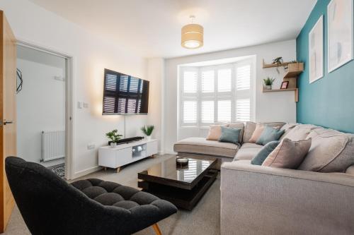 a living room with a couch and a table at Modern Hove Home close to Brighton Beach with FREE PARKING in Brighton & Hove