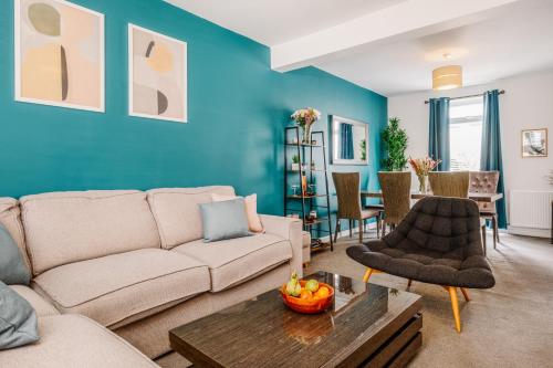 a living room with a couch and a table at Modern Hove Home close to Brighton Beach with FREE PARKING in Brighton & Hove
