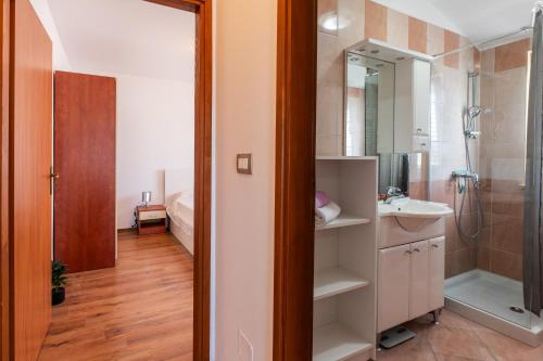 a bathroom with a sink and a shower at Apartments GreenHouse in Pomer