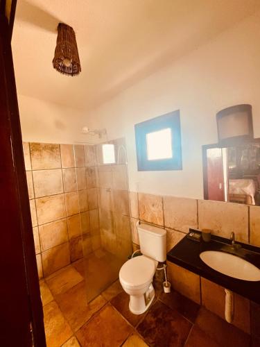 a bathroom with a toilet and a sink and a shower at Ondas do Mar in Taíba