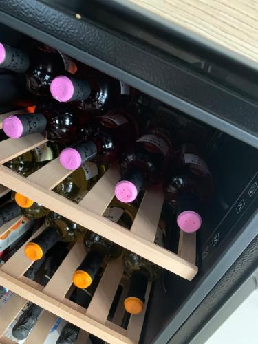 a bunch of bottles of wine in a refrigerator at Marconi B&B - Holiday Home in Marconia