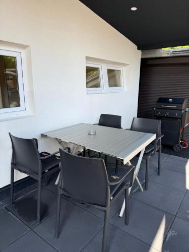 a table and chairs in a room with a stove at Mobile House LaSiesta Thermal park Terme 3000 in Moravske Toplice