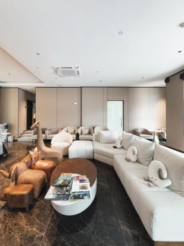 a large living room with couches and tables at Moon Hotel in George Town