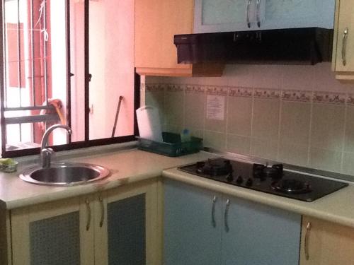 a kitchen with a sink and a counter top at HP Vacation Marina Court in Kota Kinabalu