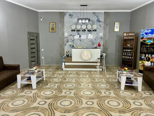 a living room with two tables and a tv at Garden F Sheki in Sheki