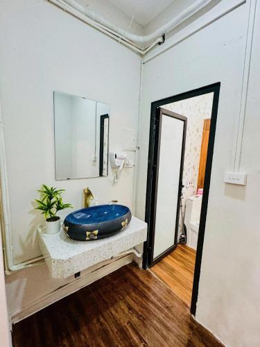 a bathroom with a blue tub sitting on a counter at SuGar Homestay in Hanoi