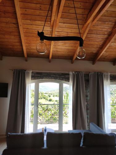 a living room with a couch and a window at Ανέμη in Panayía