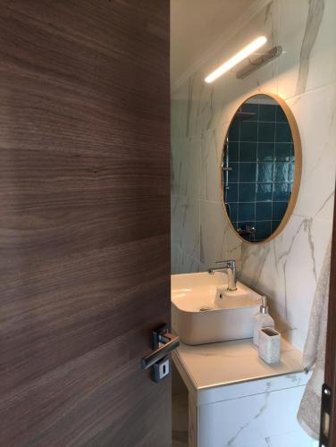 a bathroom with a sink and a mirror at Ανέμη in Panayía