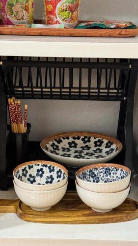 three bowls are sitting on a shelf at SuGar Homestay in Hanoi