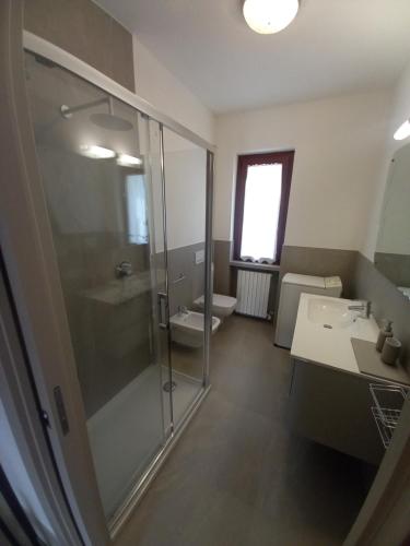 a bathroom with a shower and a sink and a toilet at IRIS casa vacanze in Carenno