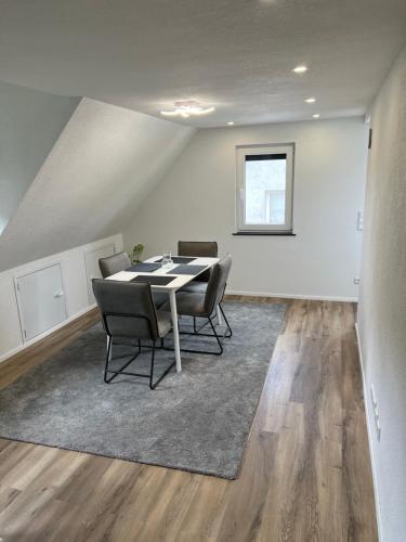 a dining room with a table and chairs at Moderne Ferienwohnung Horb-Altheim in Horb am Neckar