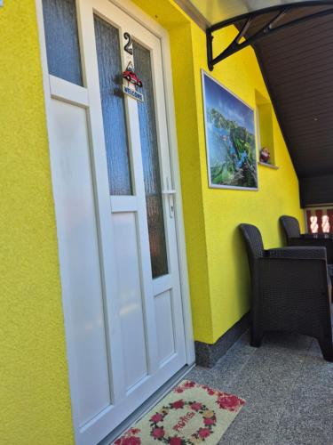 a front door of a house with yellow walls at Apartment Slap in Rakovica