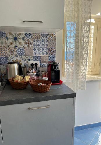 a kitchen with baskets of food on a counter at Song of the sea, Amalfi Coast in Minori