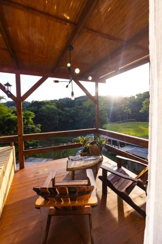 a patio with a table and chairs on a deck at Chale do Mirante in Blumenau