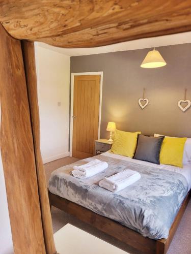 a bedroom with a bed with two towels on it at Family-Friendly Spacious 3BR, Near Uni & Town in Worcester