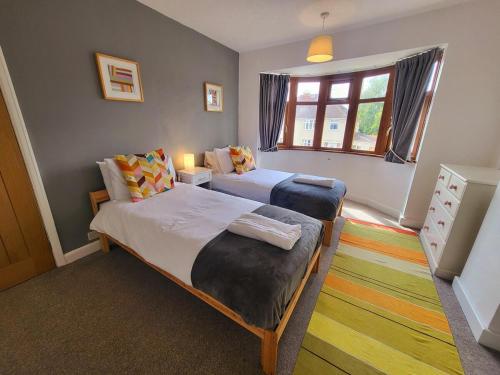 a bedroom with two beds and a window at Family-Friendly Spacious 3BR, Near Uni & Town in Worcester