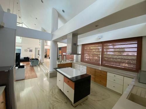 a large kitchen with white cabinets and a black island at RB Villa in Kanāria
