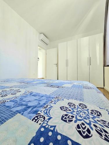a large bedroom with a blue and white bed at Bepo in Zadar