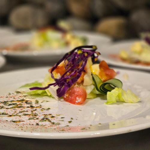 a white plate with food on a table at Molino de Café Cabañas Lodge in Chinchín Loma
